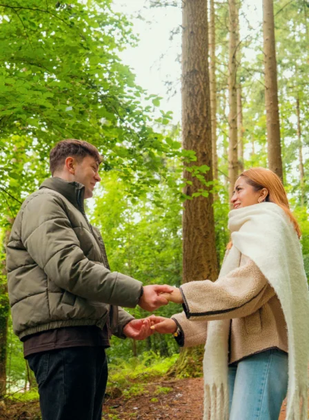 A couple holding hands on a forest path near The Gateway Hotel Dundalk.