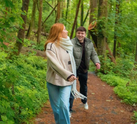 A couple enjoys a walk through lush green forests near The Gateway Hotel Dundalk.