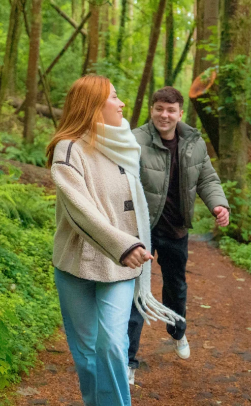A couple enjoys a walk through lush green forests near The Gateway Hotel Dundalk.