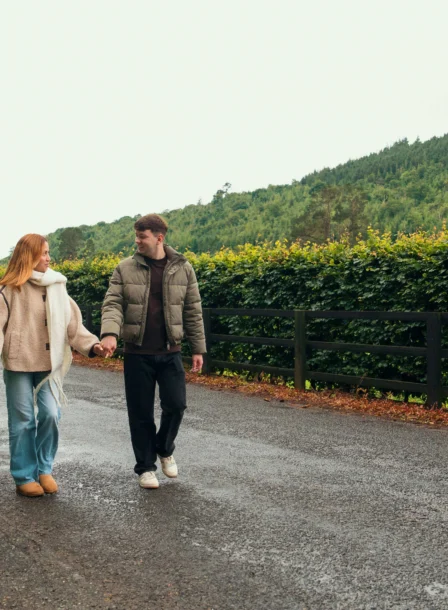A couple strolls hand-in-hand along a country road by The Gateway Hotel in Dundalk.
