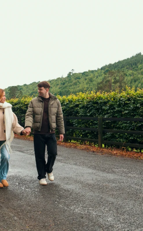 A couple strolls hand-in-hand along a country road by The Gateway Hotel in Dundalk.