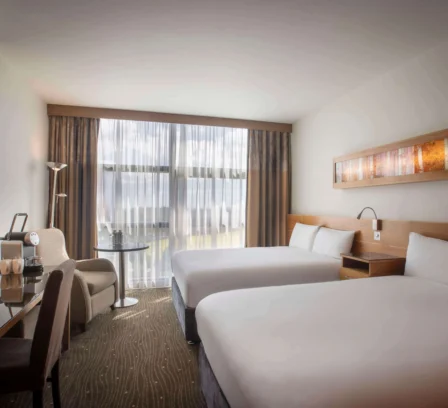 Modern hotel room with two comfy beds and natural light at The Gateway Hotel Dundalk.