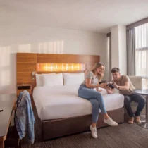 Couple leisurely enjoying a bright, modern hotel room at The Gateway Hotel Dundalk.