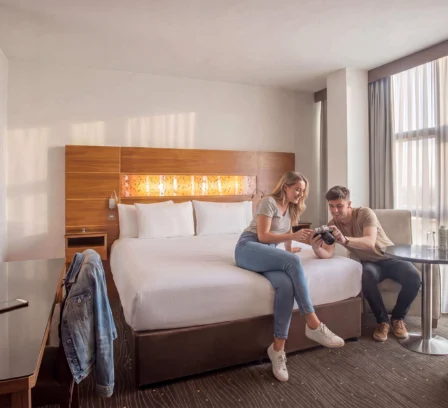 Couple leisurely enjoying a bright, modern hotel room at The Gateway Hotel Dundalk.