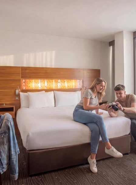 Couple leisurely enjoying a bright, modern hotel room at The Gateway Hotel Dundalk.