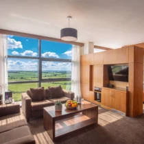 Comfortable hotel room with a lush countryside view, perfect for family relaxation.