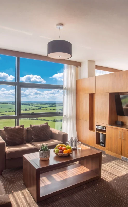 Comfortable hotel room with a lush countryside view, perfect for family relaxation.