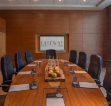 Family enjoying a meeting room at The Gateway Hotel Dundalk, Ireland, with refreshments and bright decor.