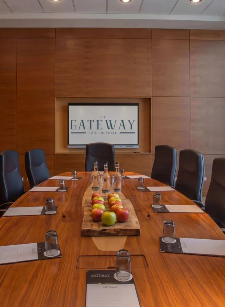 Family enjoying a meeting room at The Gateway Hotel Dundalk, Ireland, with refreshments and bright decor.
