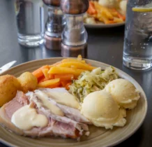 A delicious plate of roast pork, vegetables, and mashed potatoes at The Gateway Hotel.