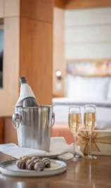 Elegant hotel room with champagne and strawberries, ideal for couples. Gateway Hotel branding visible.