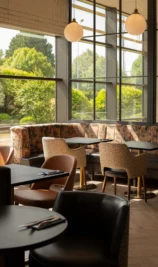 Modern, sunlit dining area at The Gateway Hotel Dundalk with lush garden views.
