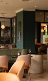 Elegant hotel dining area with warm lighting and cosy seating.