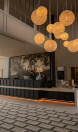 Warm hotel lobby with friendly staff at reception.