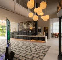 Family checking in at The Gateway Hotel Dundalk's welcoming lobby with modern decor.