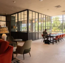 Family relaxing in Gateway Hotel's modern lounge area with garden view.