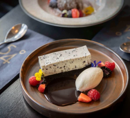 Dessert plates at The Gateway Hotel, featuring a creamy panna cotta with berries.