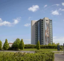 A family enjoys sunny outdoors near The Gateway Hotel Dundalk with lush greenery around.
