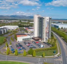Aerial view of The Gateway Hotel Dundalk with parked cars and lush green surroundings.