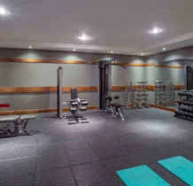 A modern gym with equipment and weights at The Gateway Hotel Dundalk.