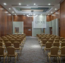 Elegant conference room setup at The Gateway Hotel Dundalk, featuring a chandelier and seating.