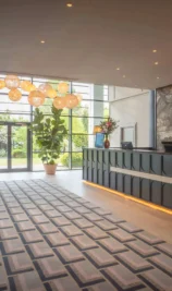 Family checking into spacious hotel lobby with elegant decor at The Gateway Hotel Dundalk.