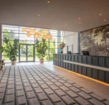 Family checking into spacious hotel lobby with elegant decor at The Gateway Hotel Dundalk.