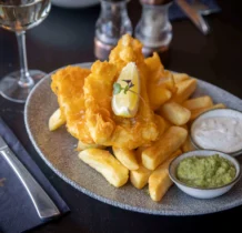 Delicious fish and chips served with tartar sauce and mushy peas at The Gateway Hotel Dundalk.