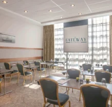 Bright meeting room in The Gateway Hotel Dundalk with tables set for a business event.