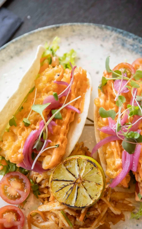 Delicious tacos with vibrant toppings and lime at The Gateway Hotel restaurant.