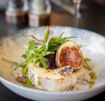 Elegant dish of cheese and figs garnished with fresh rocket at The Gateway Hotel Dundalk.