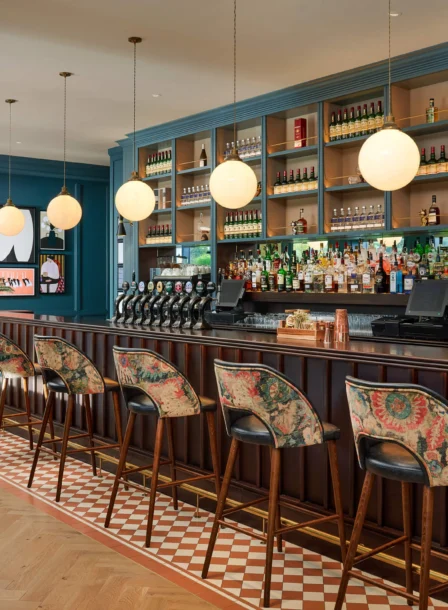 Cosy hotel bar with stylish seating and ambient lighting, inviting for family gatherings.