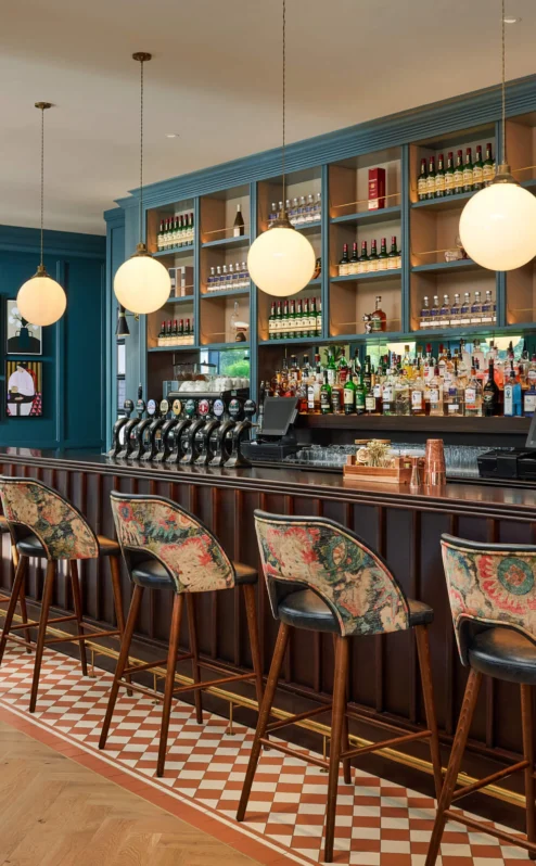 Cosy hotel bar with stylish seating and ambient lighting, inviting for family gatherings.