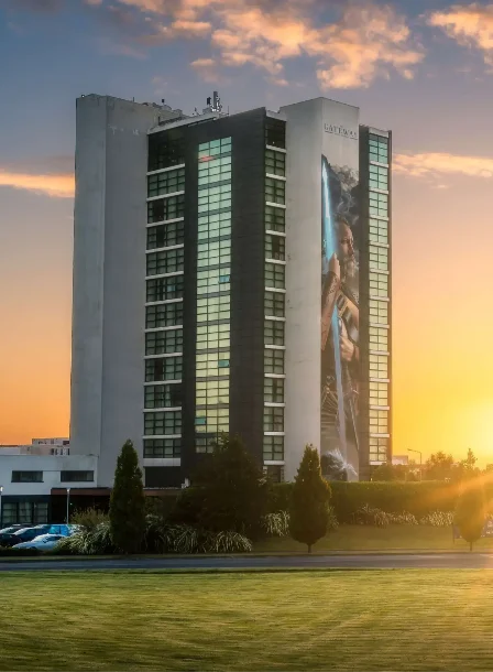 Family enjoying sunset at The Gateway Hotel Dundalk with lush green surroundings.