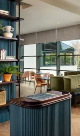 Cosy hotel lounge with seating and decorative shelves in The Gateway Hotel Dundalk.