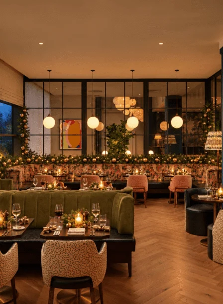 Warm hotel restaurant with a family dining together, cosy booths, candlelit tables and festive décor
